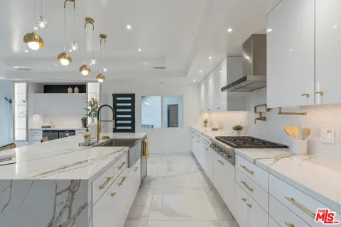 an aerial view of a house with swimming pool and garden