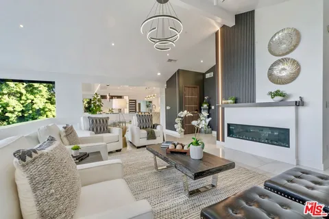 a large kitchen with stainless steel appliances kitchen island granite countertop a sink and cabinets