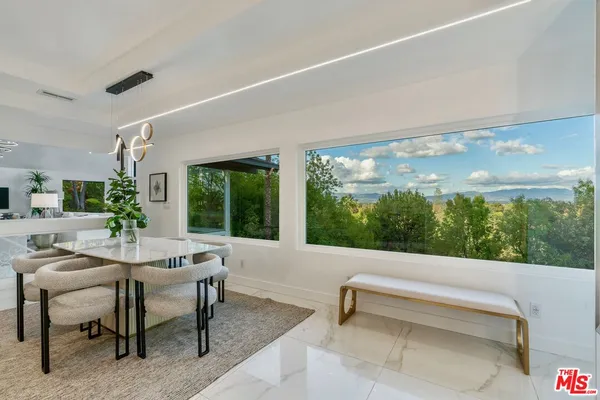 a view of a dining room with furniture window and wooden floor
