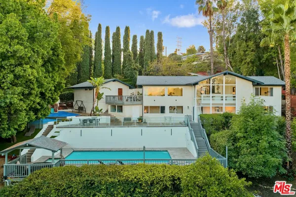 a view of houses with a yard and trees