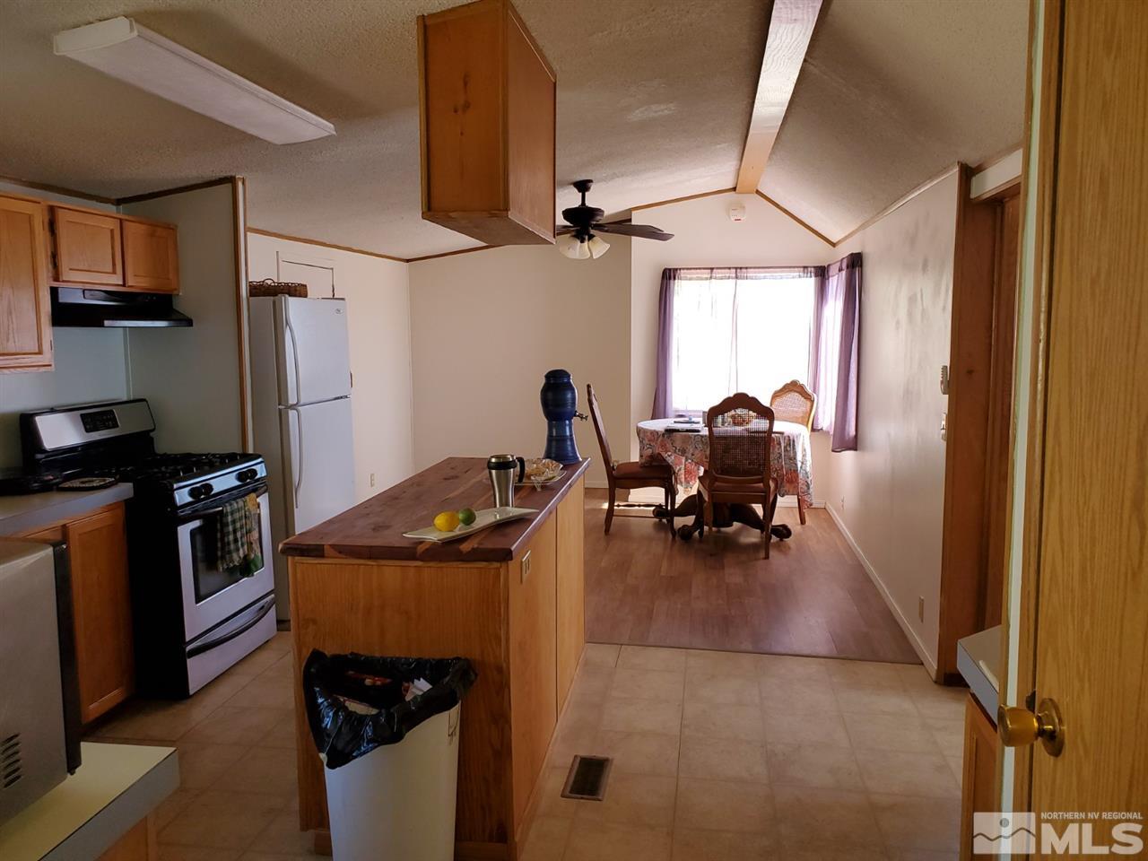 132 Lucille Drive Walker Lake, NV 89415 - Photo 13 of 36 a dining table chair next to a window