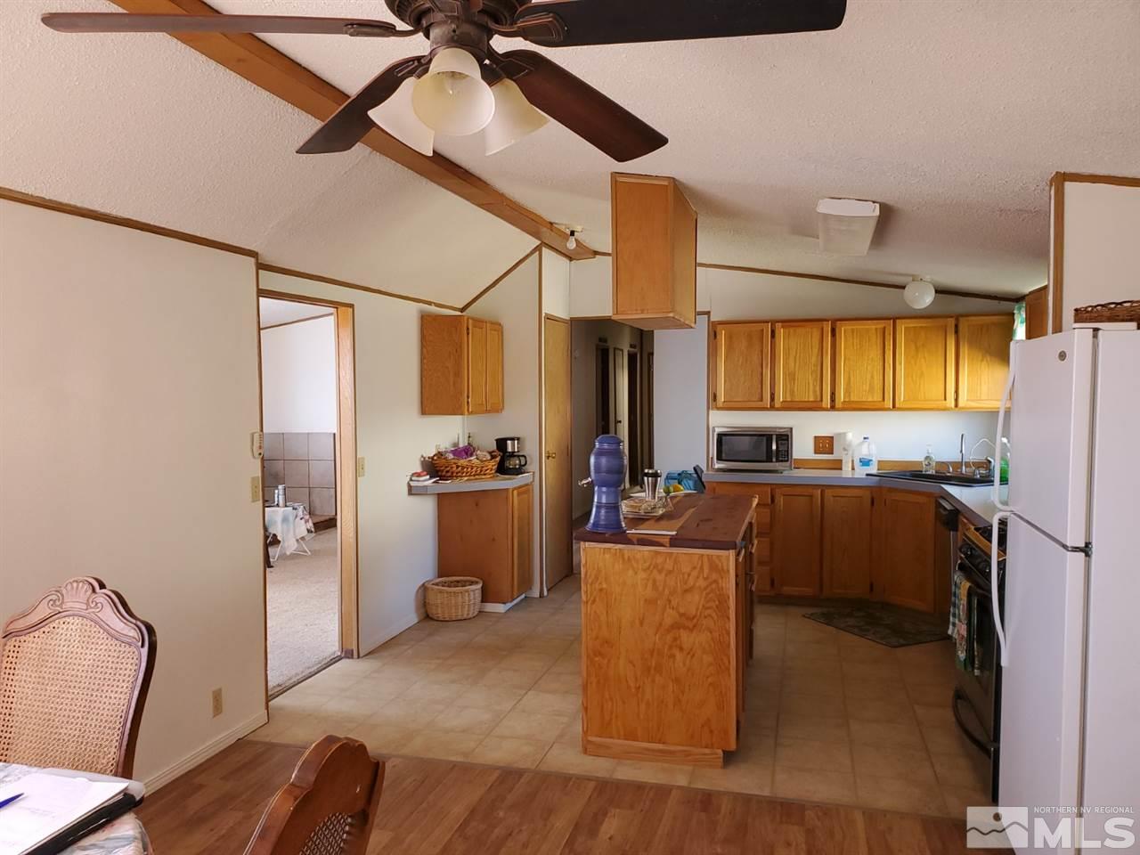 132 Lucille Drive Walker Lake, NV 89415 - Photo 14 of 36 a living room with furniture a ceiling fan and a window