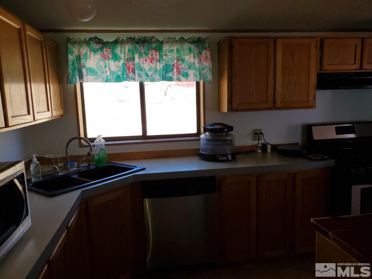 132 Lucille Drive Walker Lake, NV 89415 - Photo 15 of 36 a kitchen with a sink cabinets and window