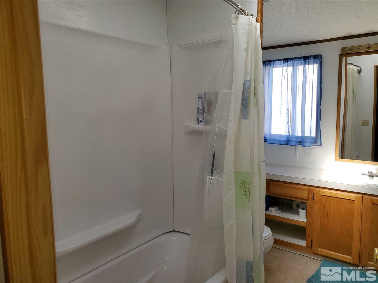 132 Lucille Drive Walker Lake, NV 89415 - Photo 26 of 36 a bathroom with a bathtub and a shower