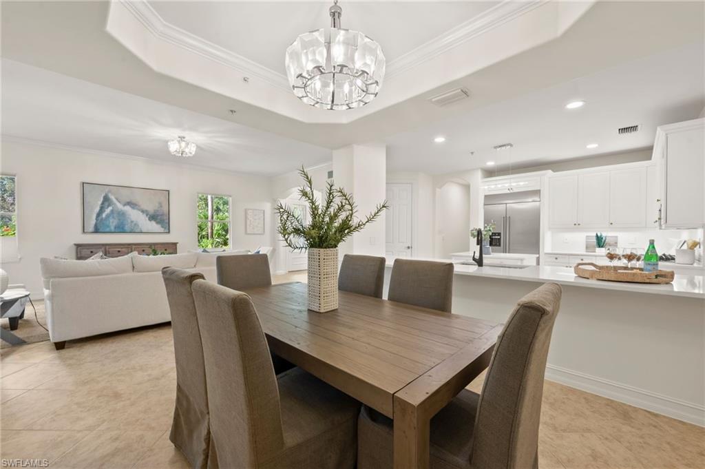 2886 Castillo Court, Unit 101 Naples, FL 34109 - Photo 12 of 45 a dining room with furniture and window