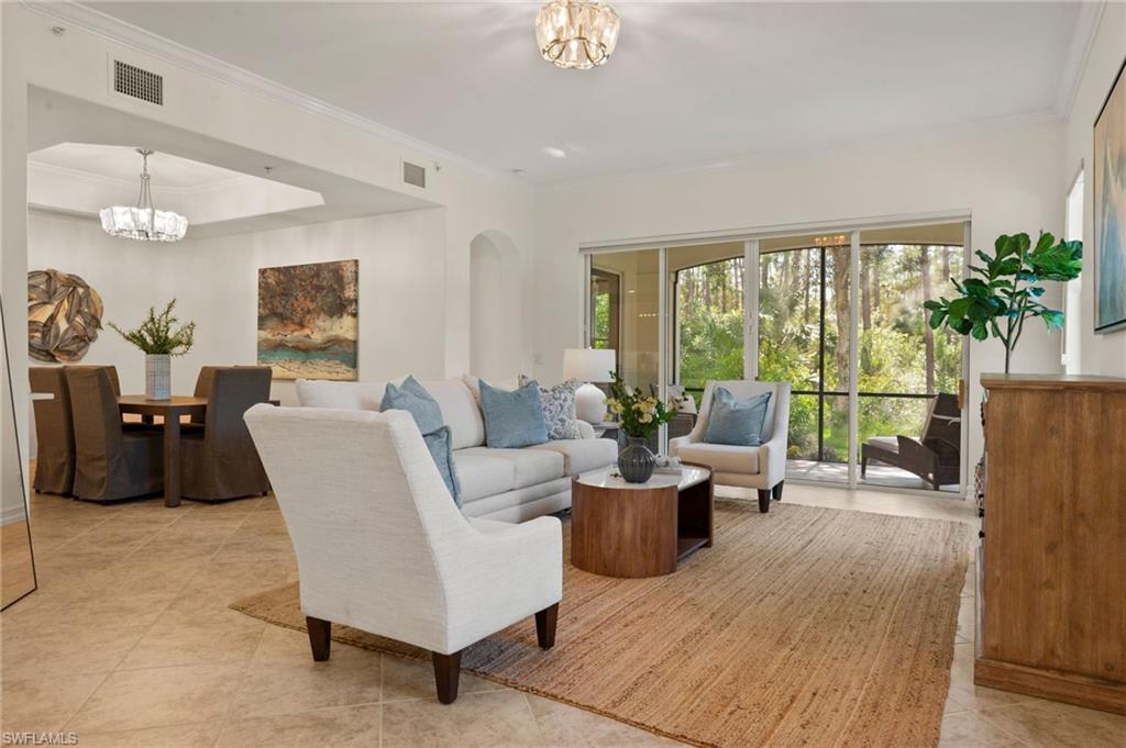 2886 Castillo Court, Unit 101 Naples, FL 34109 - Photo 13 of 45 a living room with furniture and a large window