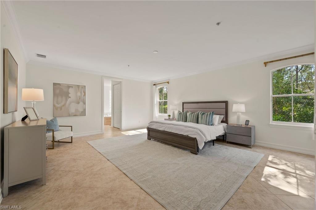 2886 Castillo Court, Unit 101 Naples, FL 34109 - Photo 14 of 45 a spacious bedroom with a bed and a couch