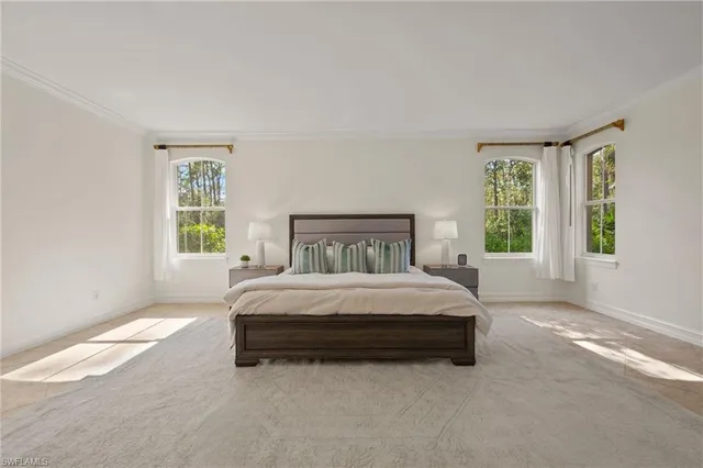 a spacious bedroom with a large bed and a window