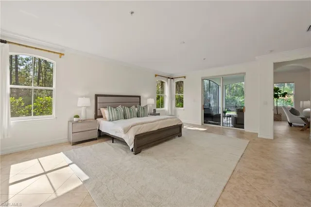 a bathroom with a tub a window and a shower