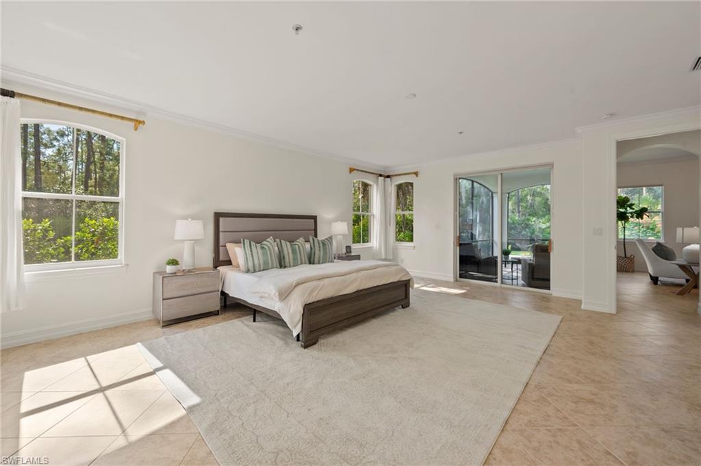 2886 Castillo Court, Unit 101 Naples, FL 34109 - Photo 16 of 45 a spacious bedroom with a large bed and a window