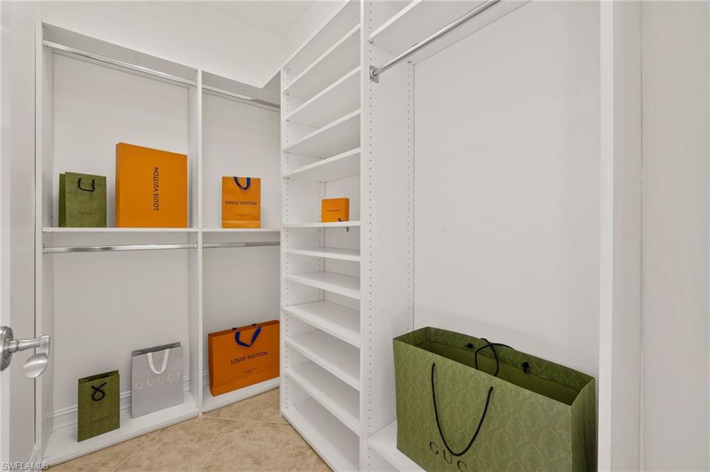 2886 Castillo Court, Unit 101 Naples, FL 34109 - Photo 19 of 45 a bathroom with a sink and mirror