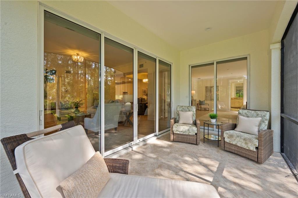 2886 Castillo Court, Unit 101 Naples, FL 34109 - Photo 22 of 45 a living room with furniture and a large window