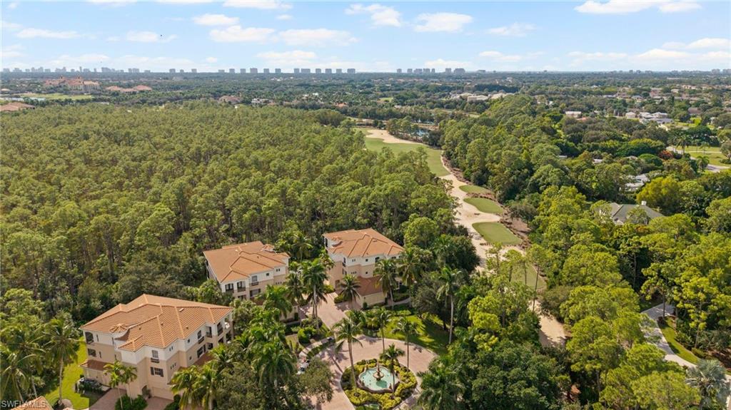2886 Castillo Court, Unit 101 Naples, FL 34109 - Photo 33 of 45 a view of a lake with a city