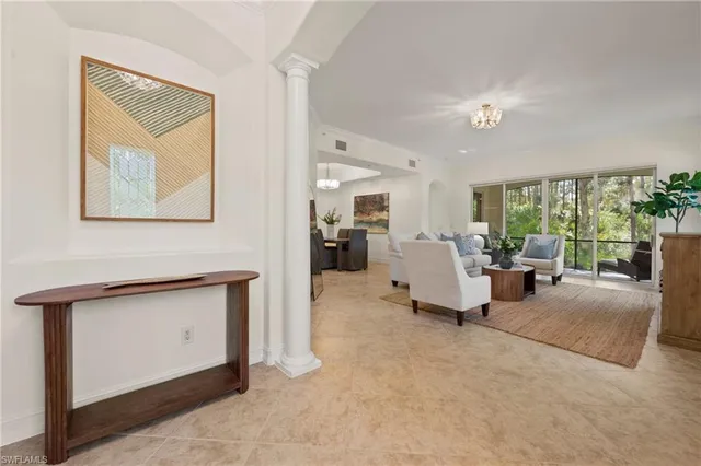 a living room with furniture a fireplace and a painting