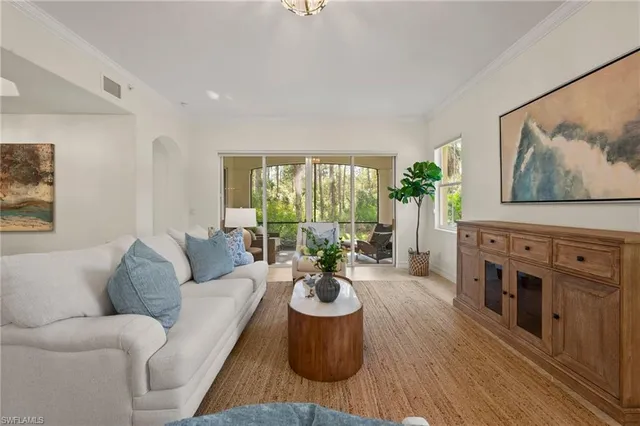 a living room with furniture a fireplace and a large window