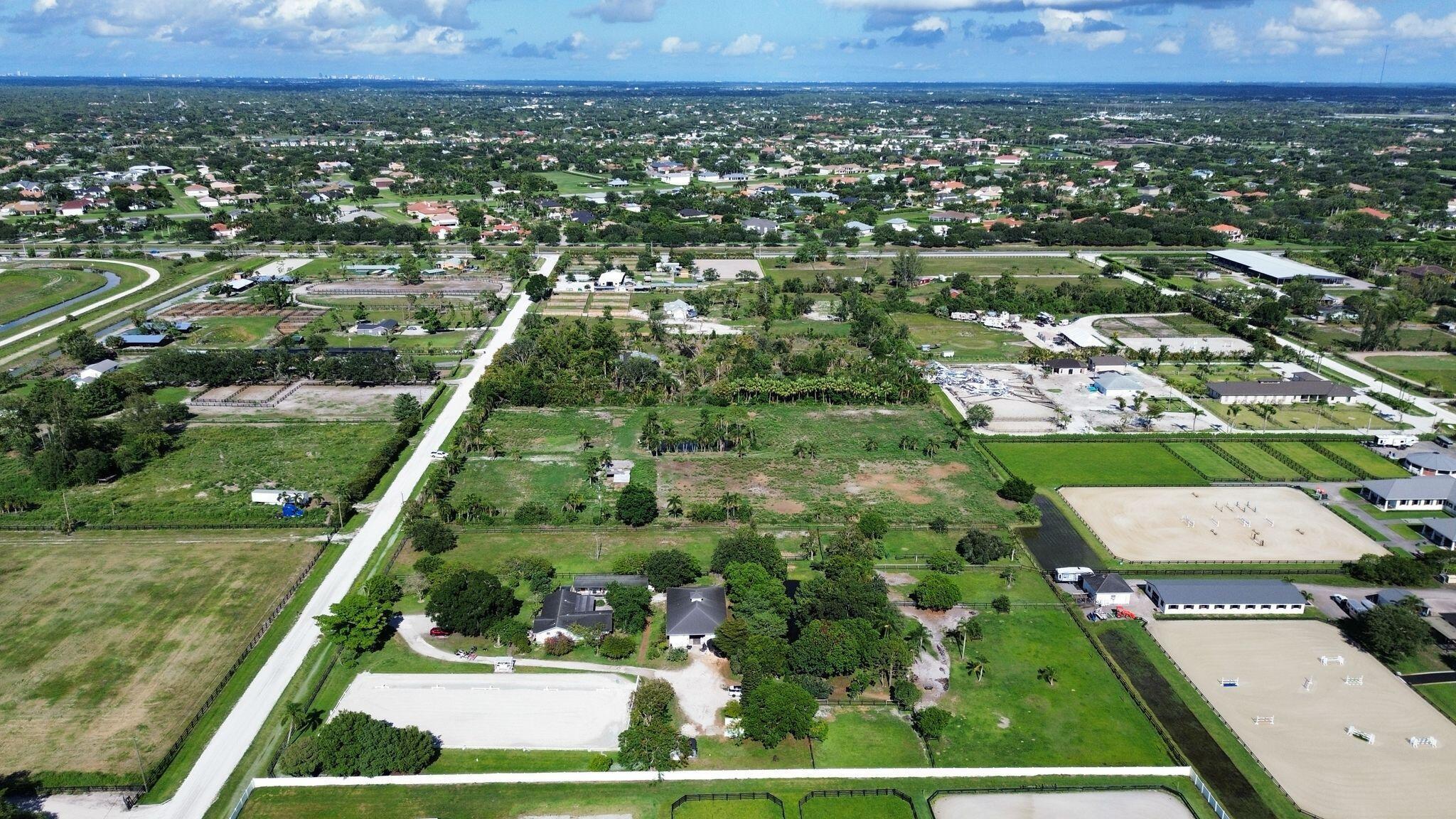16290 Rustic Road Wellington, FL 33470 - Photo 7 of 20 an aerial view of residential houses with outdoor space and trees