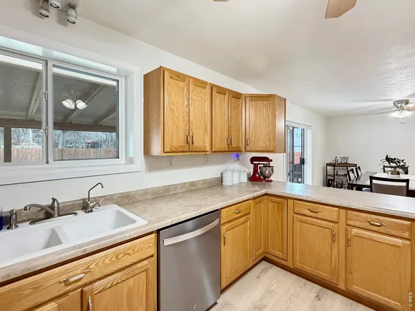 a kitchen with a sink cabinets and window