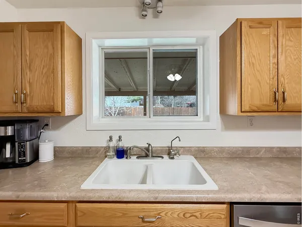 a kitchen with granite countertop a sink and a window