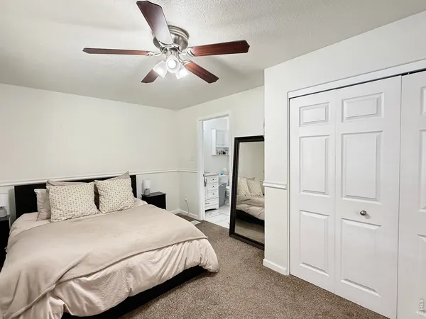 a bedroom with a bed and cabinets