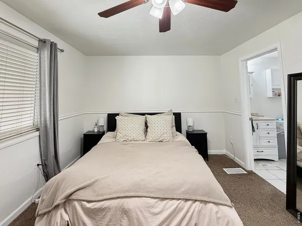 a bedroom with a bed and a lamp