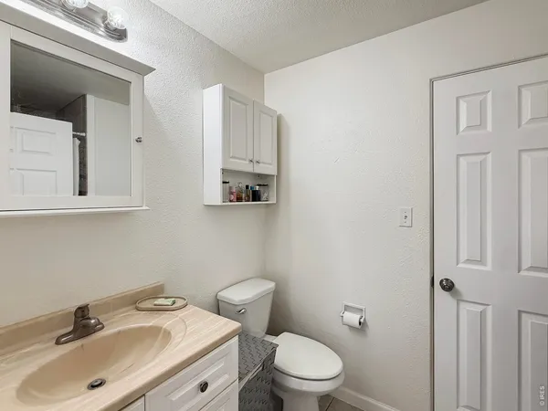 a bathroom with a sink toilet and vanity