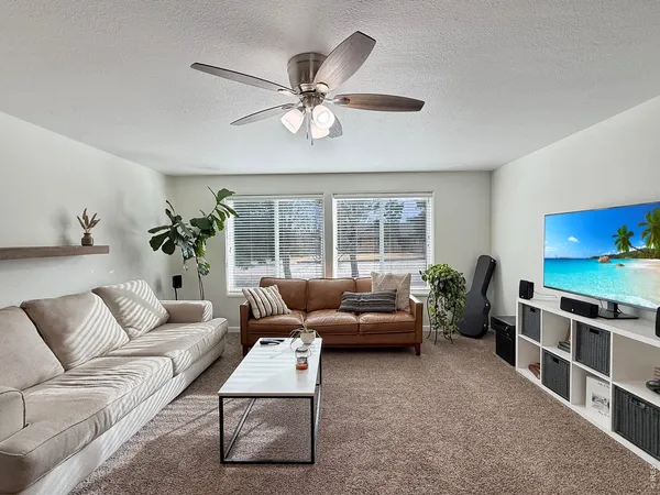 a living room with furniture tv and a window
