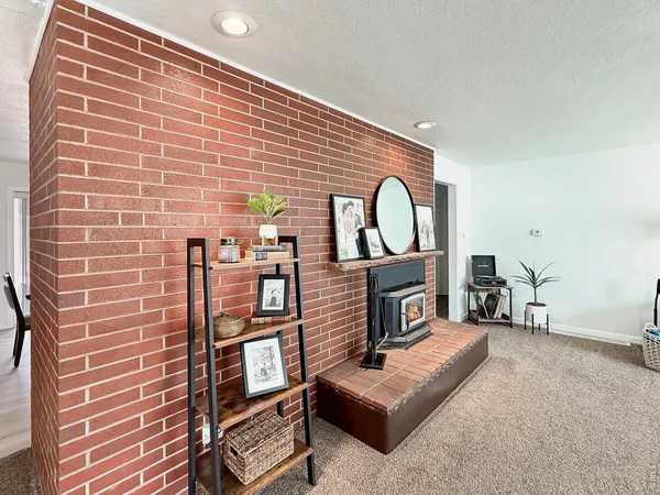 a view of a livingroom with furniture and a fireplace