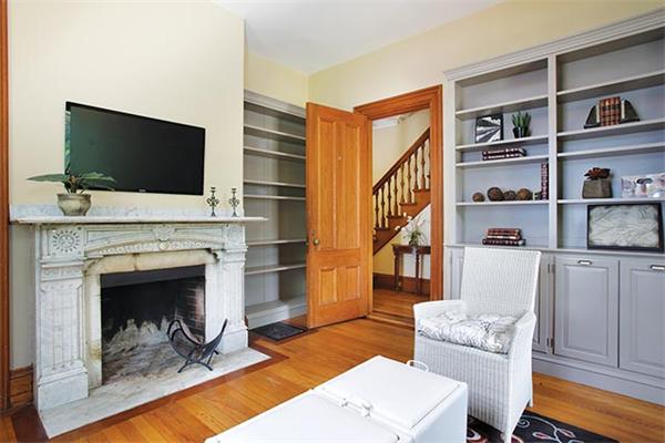 273 Walnut Street Brookline, MA 02445 - Photo 6 of 10 a living room with furniture a flat screen tv and a fireplace