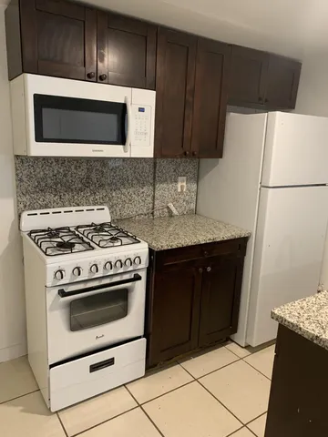 a kitchen with a stove microwave and sink