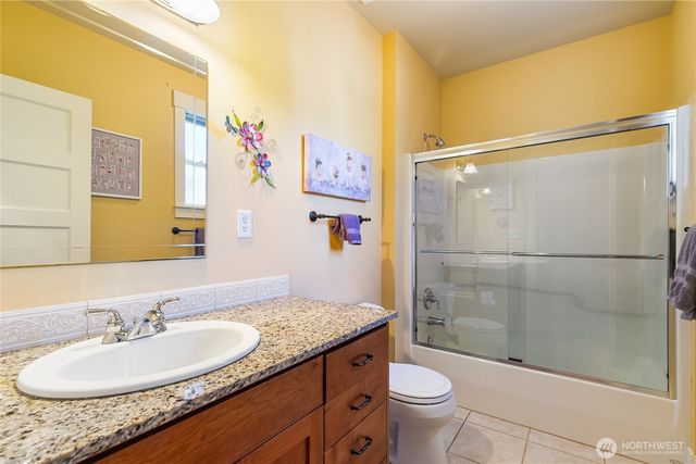 a bedroom with a bed a bookshelf and a window