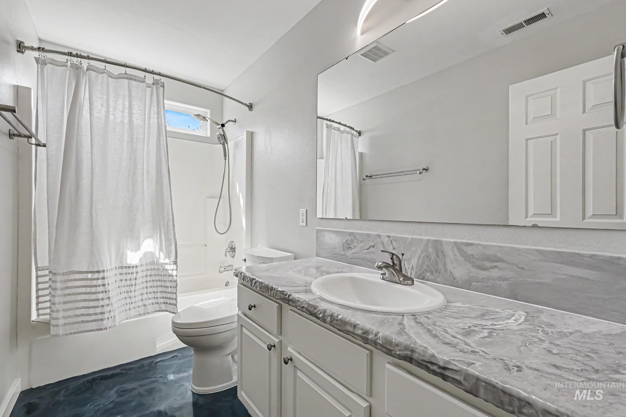 14421 West Stockwell Street Boise, ID 83713 - Photo 13 of 20 Bathroom vanity featuring a single basin sink and a stone-finish countertop with a matching backsplash