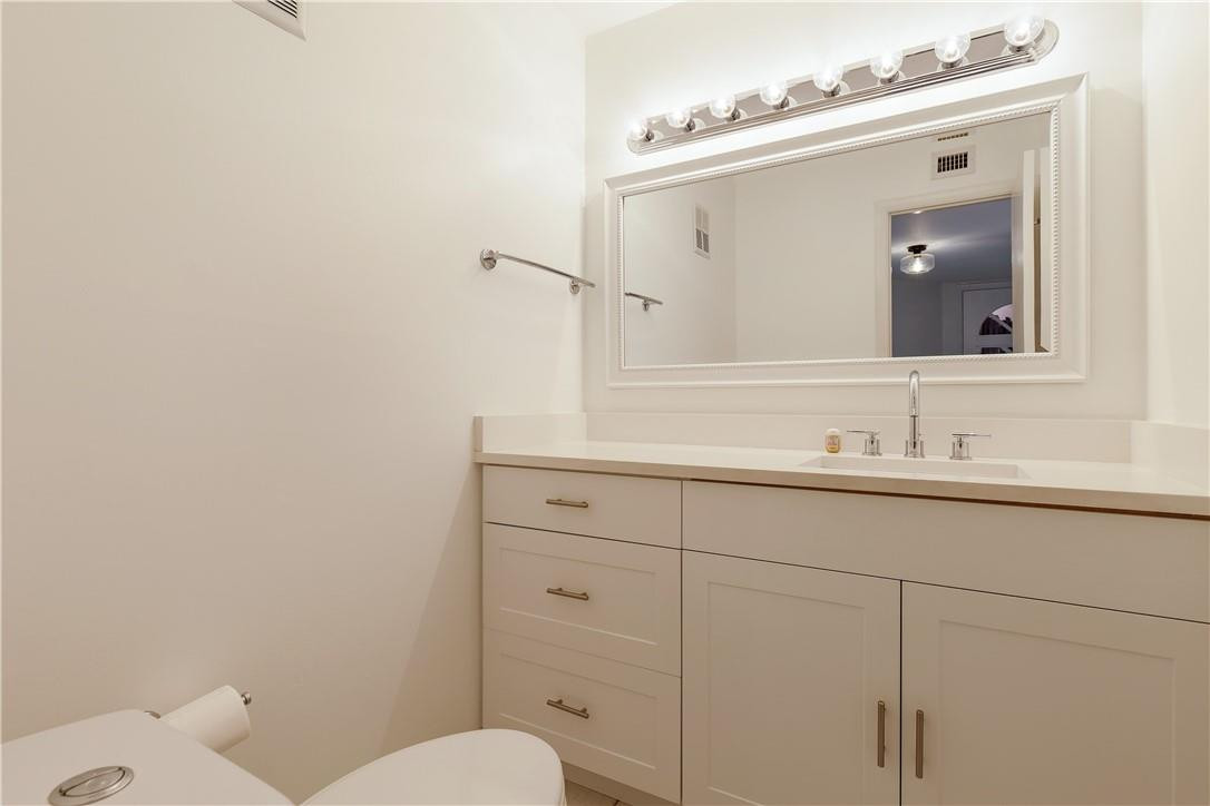 9717 North New River Canal Road, Unit 409 Plantation, FL 33324 - Photo 12 of 20 a bathroom with a toilet sink and mirror