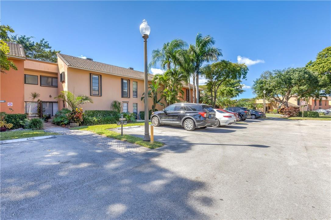 9717 North New River Canal Road, Unit 409 Plantation, FL 33324 - Photo 16 of 20 a cars parked in front of a house