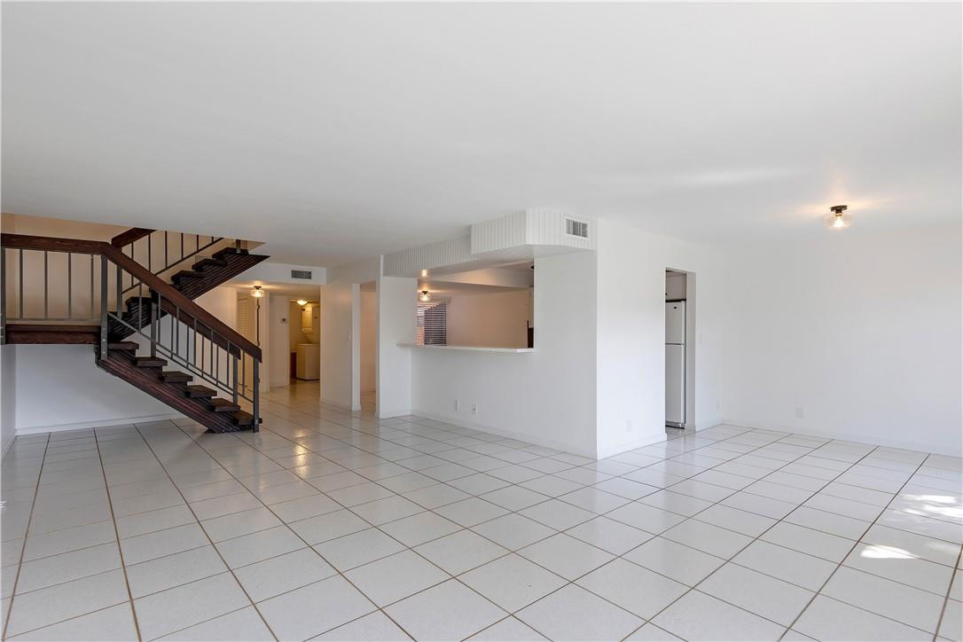 9717 North New River Canal Road, Unit 409 Plantation, FL 33324 - Photo 3 of 20 an empty room with a projector and a rug