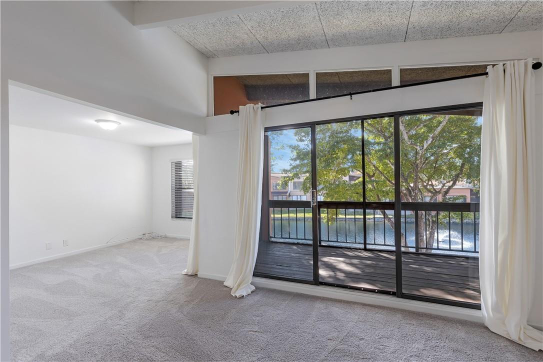 9717 North New River Canal Road, Unit 409 Plantation, FL 33324 - Photo 4 of 20 an empty room with sliding glass door and mountain view