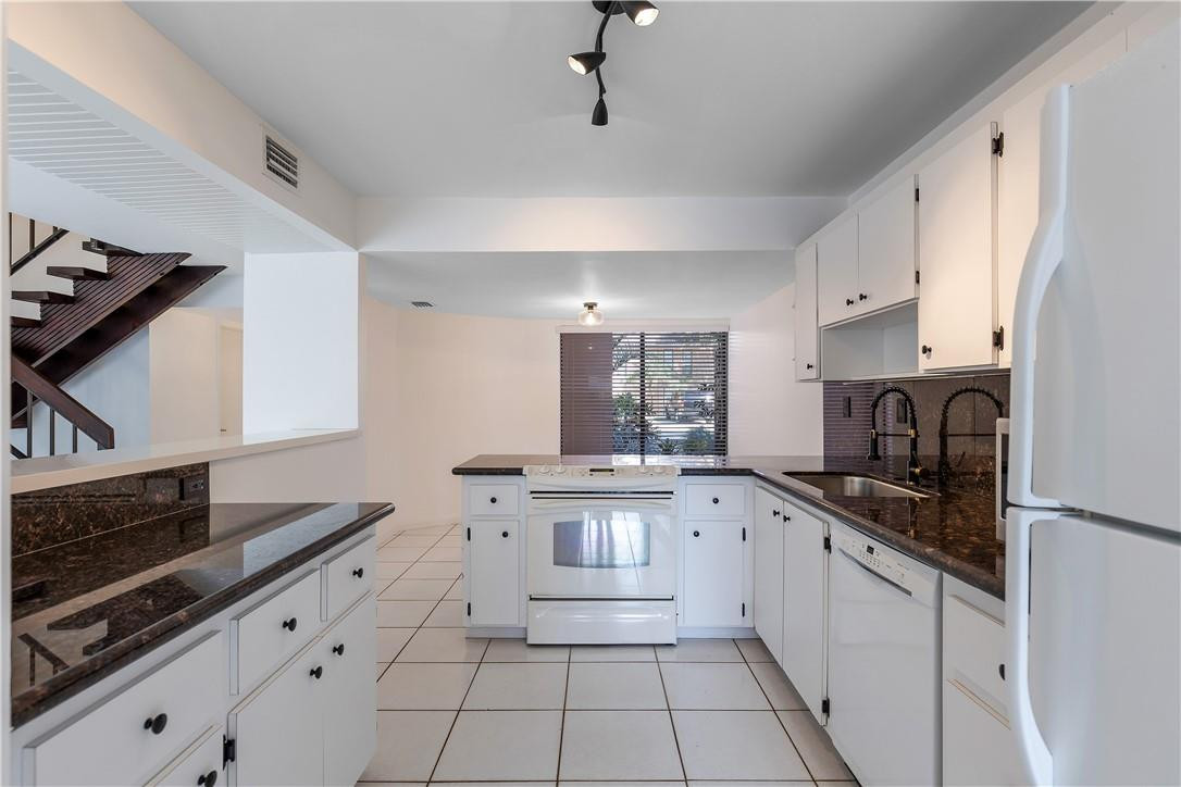 9717 North New River Canal Road, Unit 409 Plantation, FL 33324 - Photo 7 of 20 a large kitchen with a stove and a sink