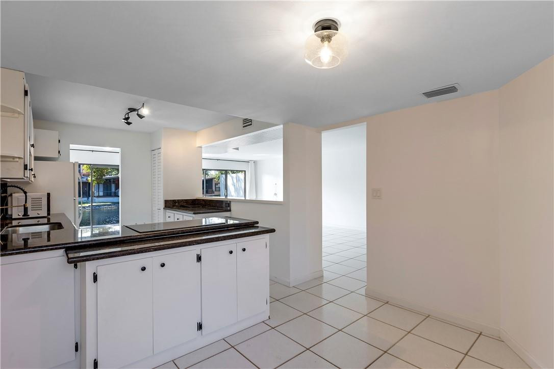 9717 North New River Canal Road, Unit 409 Plantation, FL 33324 - Photo 9 of 20 a kitchen with a sink and cabinets