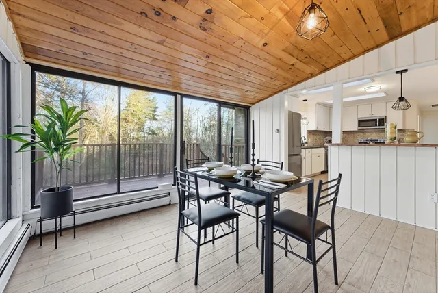 a dining room with furniture and wooden floor
