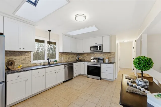 a kitchen with a sink stove and cabinets