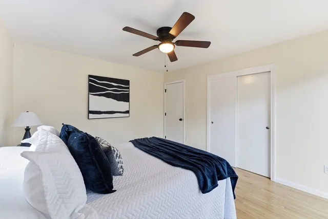 a bedroom with a bed and wooden floor