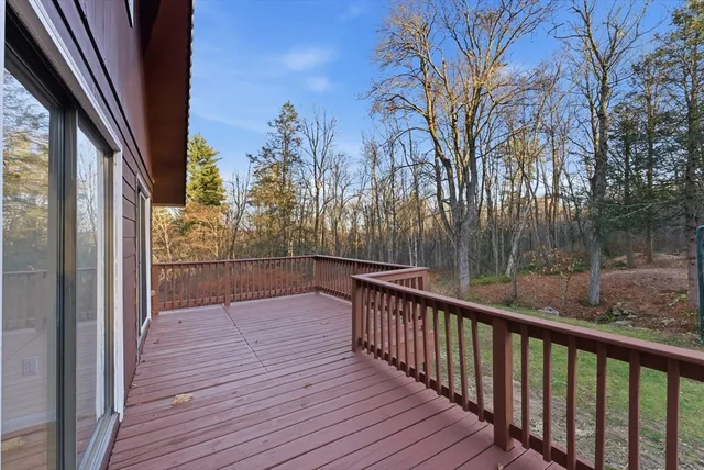 a view of balcony with wooden floor and fence