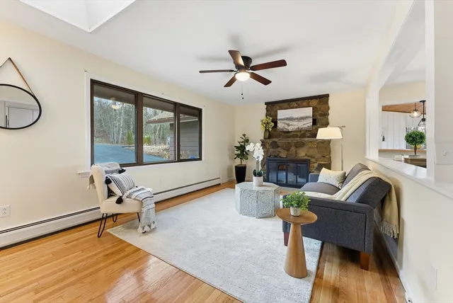 a living room with furniture a fireplace and a table