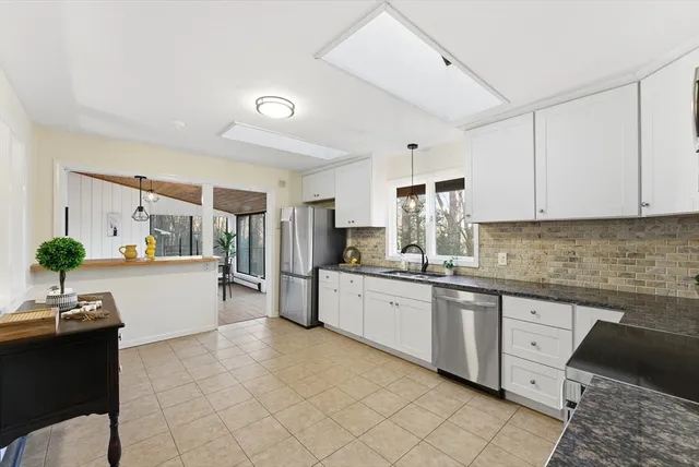 a kitchen with a sink and white cabinets