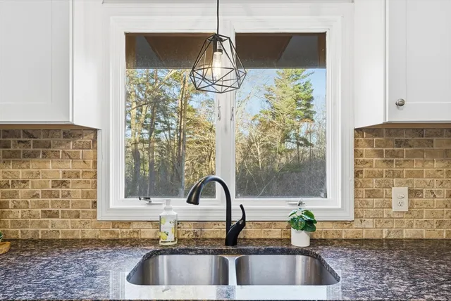 a kitchen with a sink and a large window