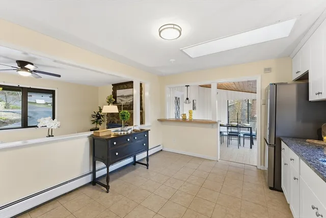 a living room with furniture and a dining table