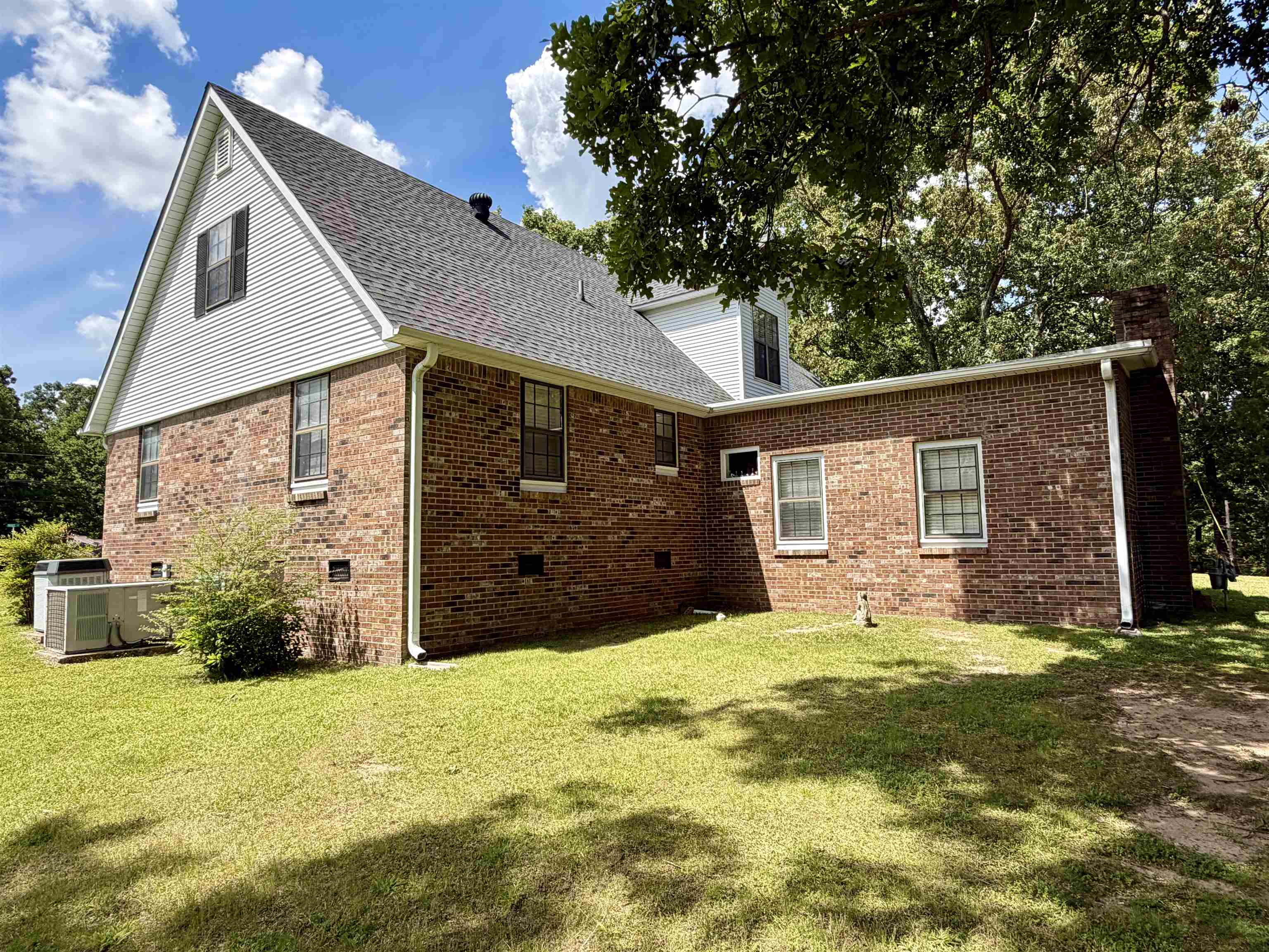142 Treece Street Selmer, TN 38375 - Photo 29 of 36 Brick exterior with white siding accents and a contrasting dark shingle roof
