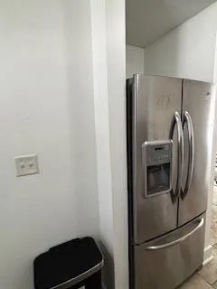 a metallic refrigerator freezer sitting in a kitchen