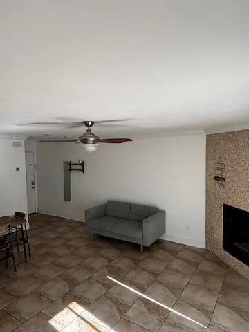 a living room with furniture a fireplace and a rug