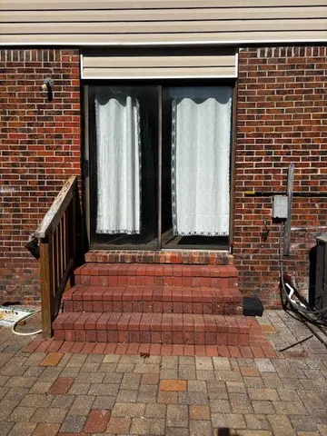 a view of a door with brick wall