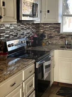 a kitchen with a stove and a microwave